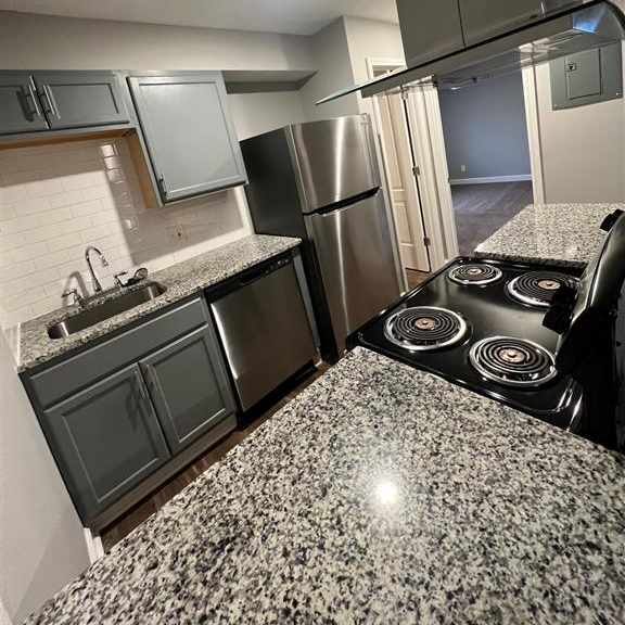 a kitchen with stainless steel appliances and granite counter tops
