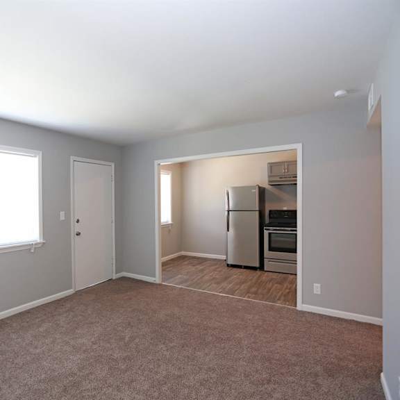 an empty living room with a window