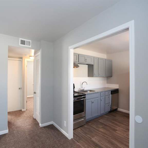 a view of a kitchen with a door to the living room