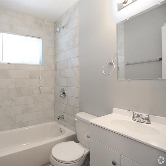 a bathroom with a bathtub toilet and sink