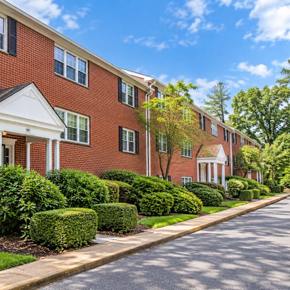 red brick apartment buildings with white porticos at the tuscan hills ahr llc apartments, baltimore, maryland
