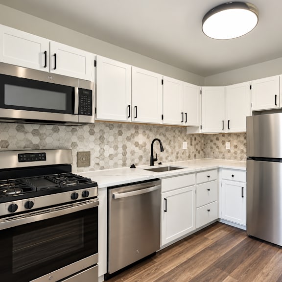 kitchen with hexagonal tile backsplash and white countertops at the tuscan hills ahr llc apartments, baltimore, 21210