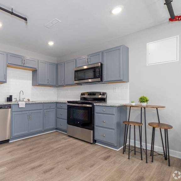 kitchen with cabinets at university digs apartments, pittsburg, ks, 66762