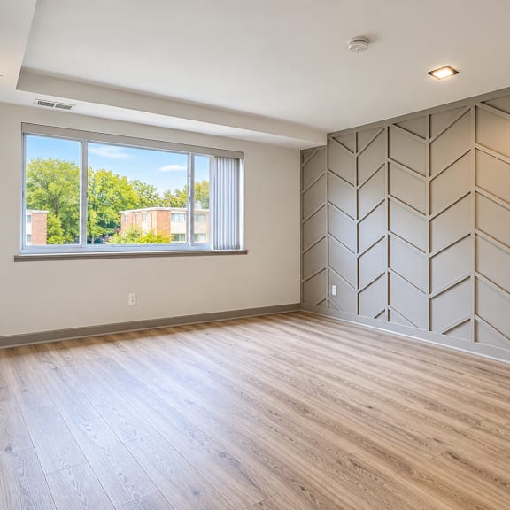 spacious room with chevron accent wall at the wyman hills ahr llc apartments, maryland