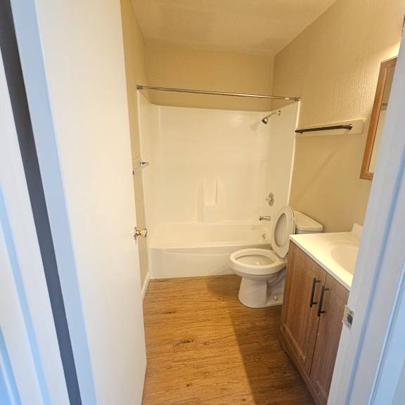 a bathroom with a toilet, sink and shower.