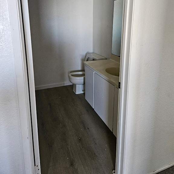 Thumbnail 10 of 12 an empty bathroom with a toilet and a sink