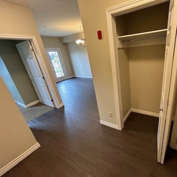 a room with a white door and a brown floor.