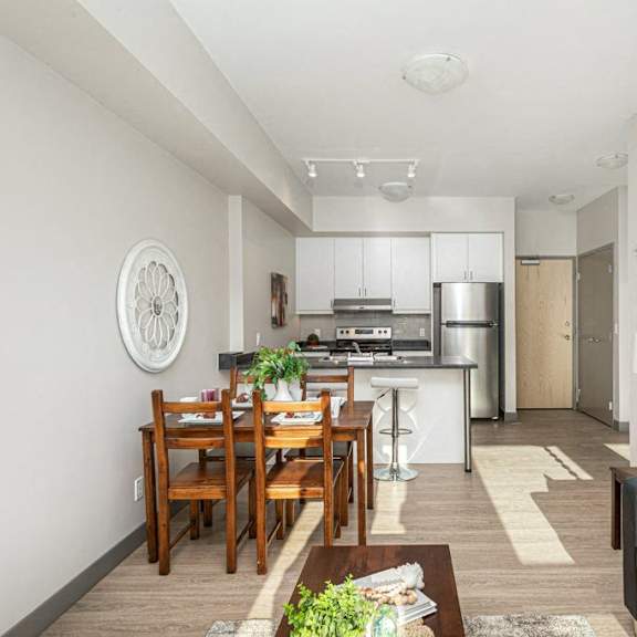 a modern kitchen with a dining table and a couch.