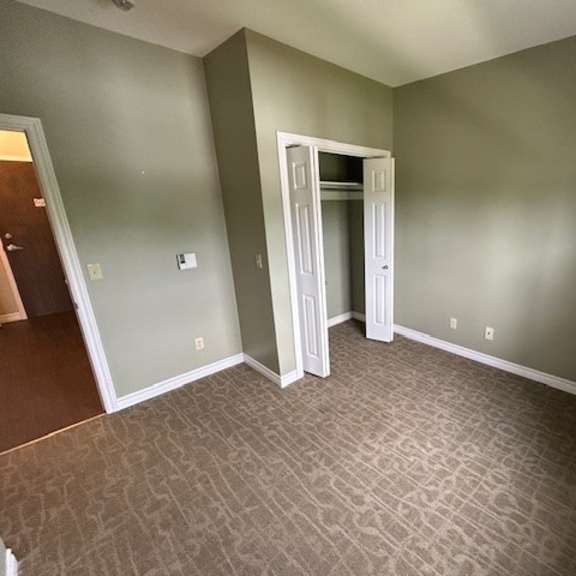 a room with a carpeted floor and a doorway leading to another room.