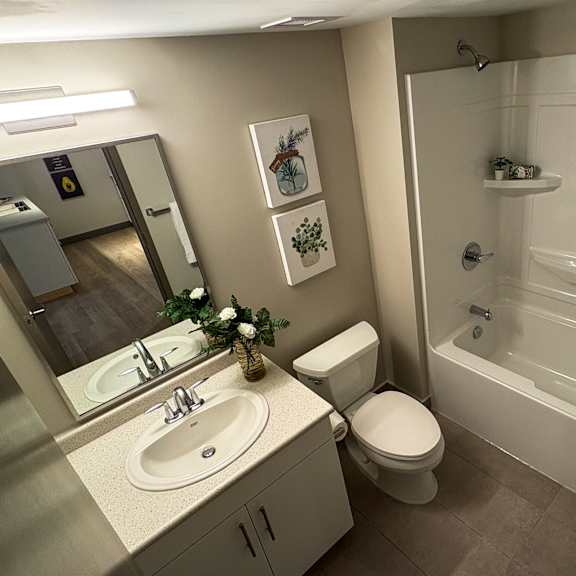 a bathroom with a toilet, sink, and bathtub.