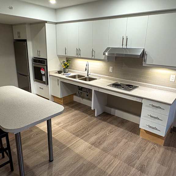 a modern kitchen with a table and chairs.