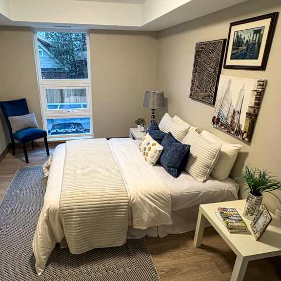 a bedroom with a large bed and a chair.