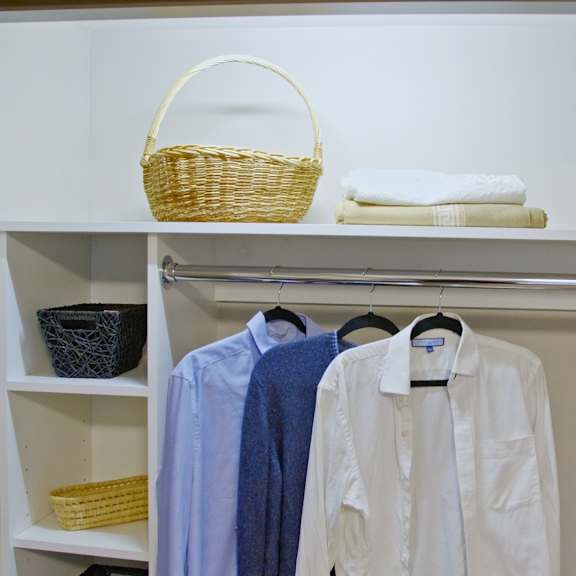 a white shirt is hanging on a hanger.