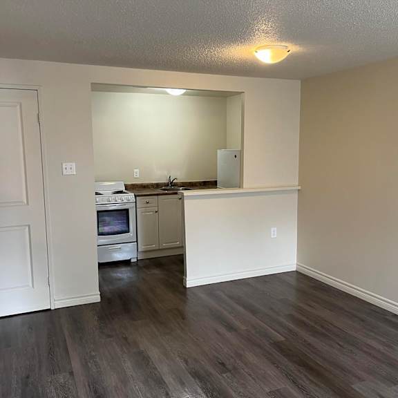 a kitchen with a white countertop and a white oven.