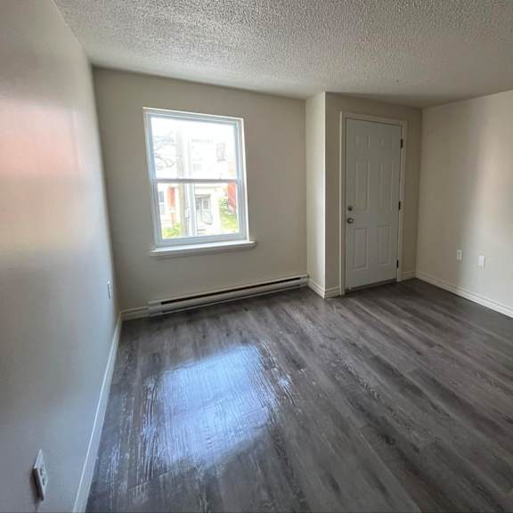 a room with a grey floor and a white door.
