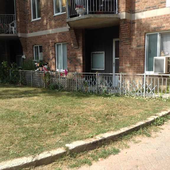 a brick building with a balcony and a metal railing.