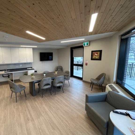 a modern kitchen with a dining table and chairs.