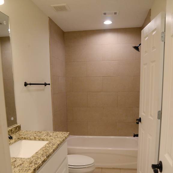 a bathroom with a toilet, sink, and bathtub.