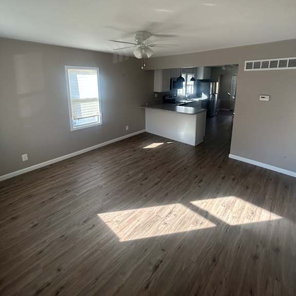 a long hallway with a window at the end.