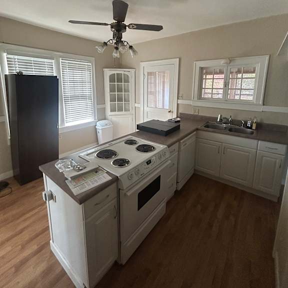 a kitchen with a fan and a stove top oven.