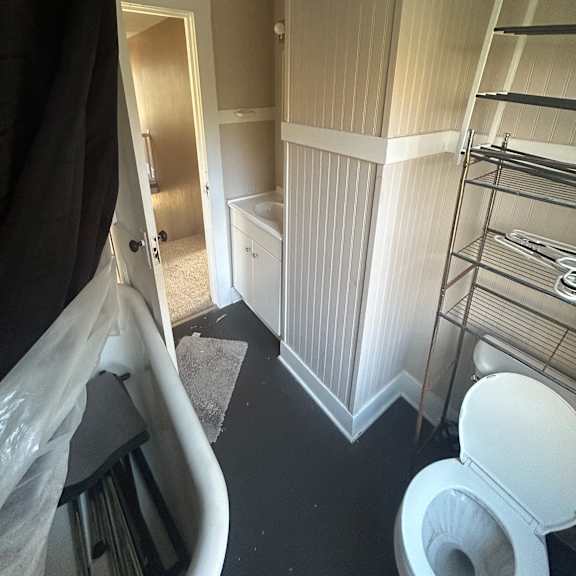 a room with a ceiling fan and a light fixture.