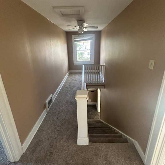 a long hallway with a window at the end.
