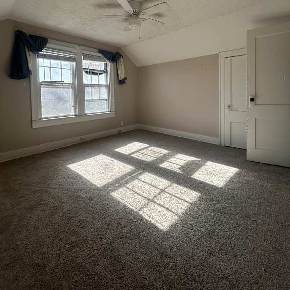 a window with a fan on the wall.
