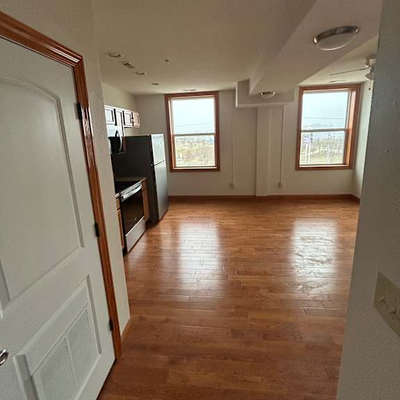 a room with wooden walls and a white ceiling with a window.