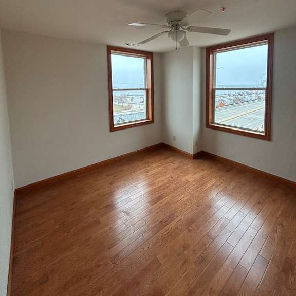 a room with a ceiling fan and skylights.