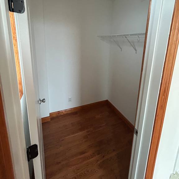 a white cabinet with a black handle and a small black object on the counter.