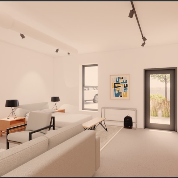 a living room with a white couch, a small table with a lamp, and a painting on the wall.