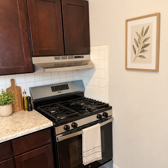 a black stove top oven with a white towel on it.