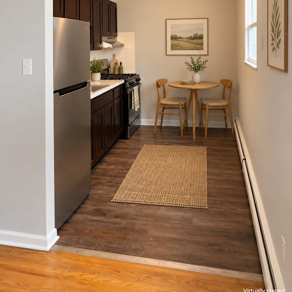 a kitchen with a table and chairs in the middle of the room.