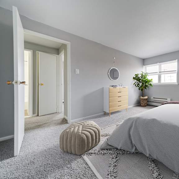 a bedroom with a large bed and a rug on the floor.