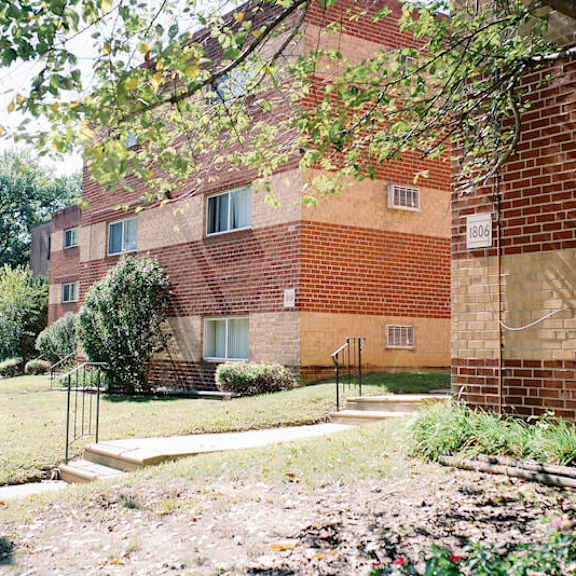 a brick building with a sidewalk in front of it
