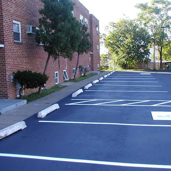 an empty parking lot in front of a brick building