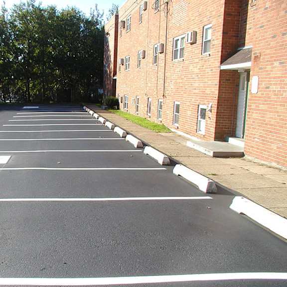 an empty parking lot next to a brick building