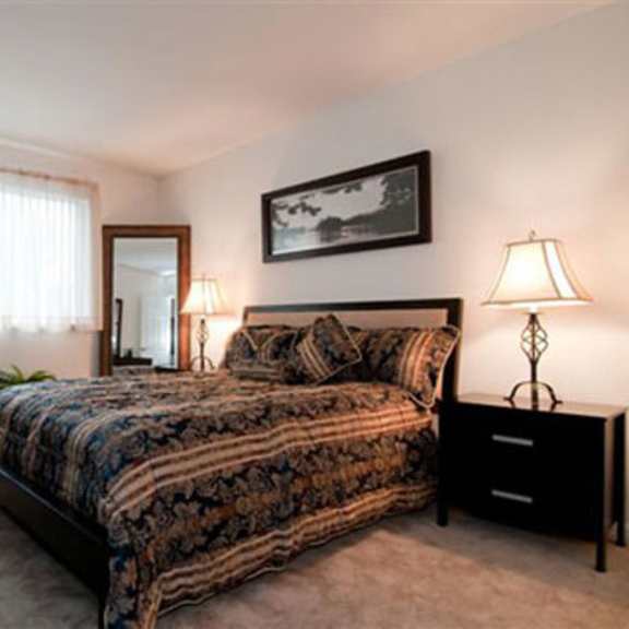 a bedroom with a bed and a dresser