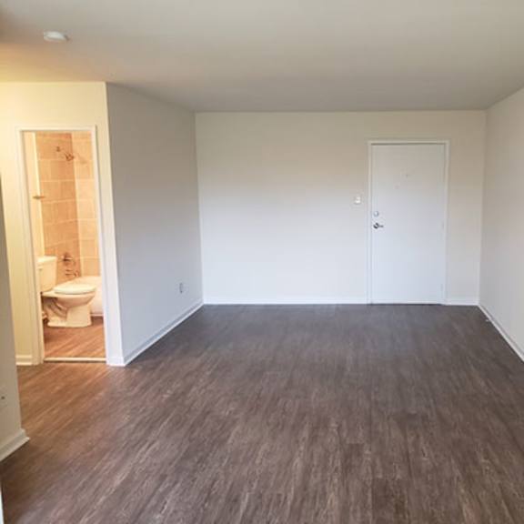 an empty room with a toilet and a door