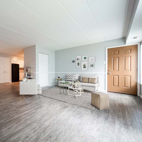 a spacious living room with a dining table and chairs.