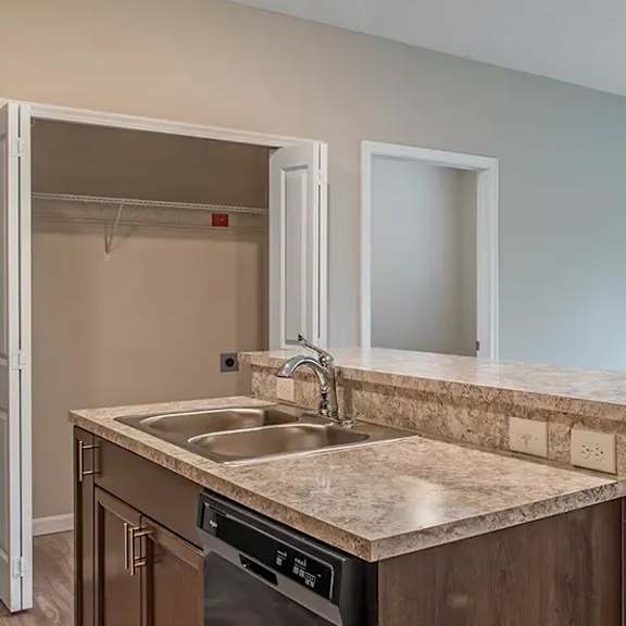 an empty kitchen with a sink and an open door