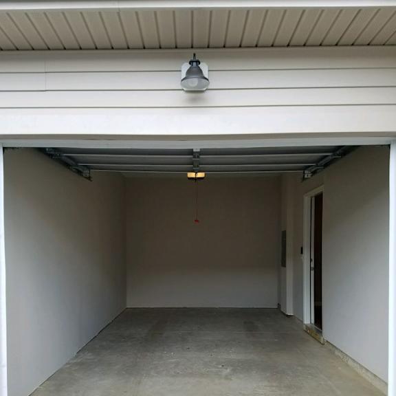 an empty garage in a building with a light on the ceiling
