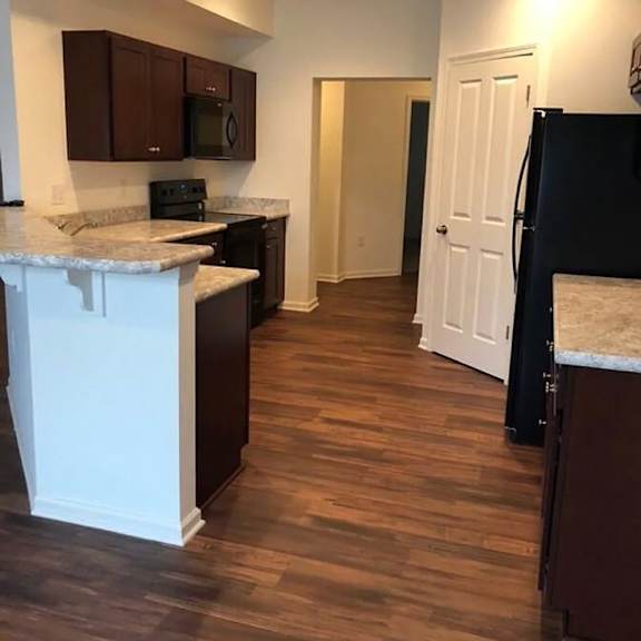 a view of a kitchen with a wood floor