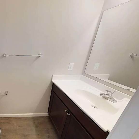 a bathroom with a toilet and a sink and a mirror