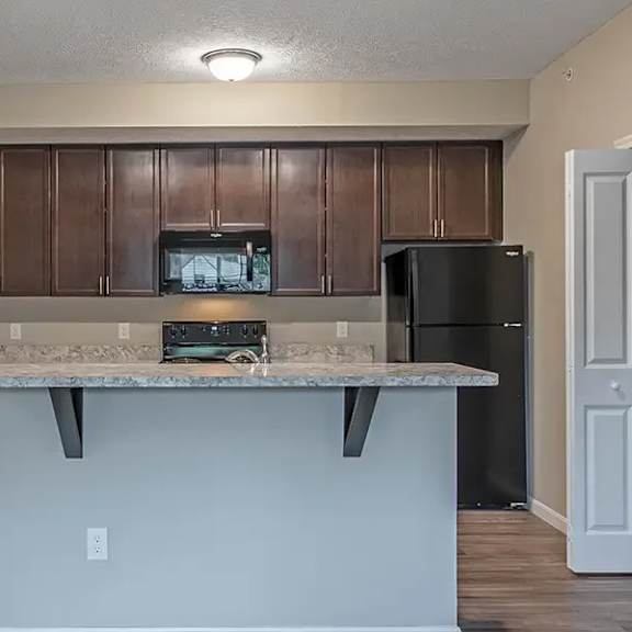 a kitchen with a counter top and a refrigerator