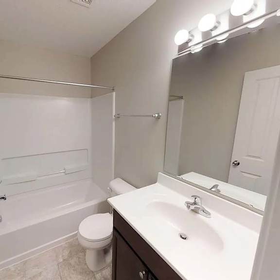 a bathroom with a sink and a toilet and a shower