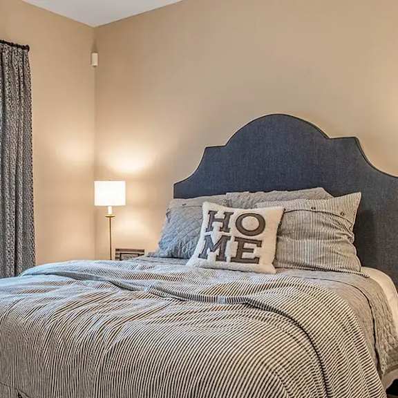 a bedroom with a bed and a window