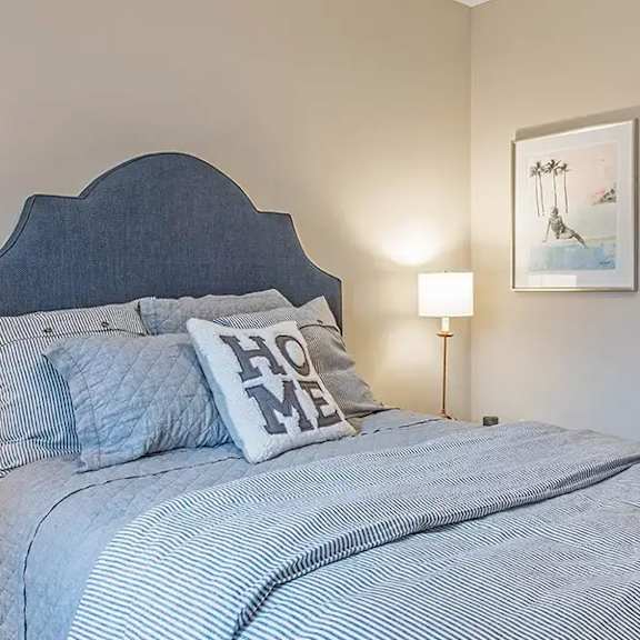 a bedroom with a bed and a bathroom with a toilet