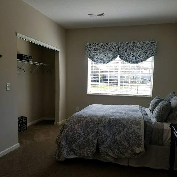 a bedroom with a large bed and a window