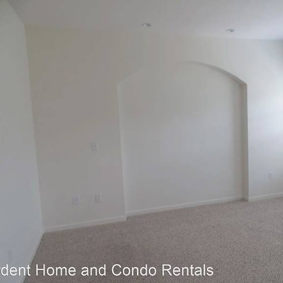 an empty room with white walls and a window